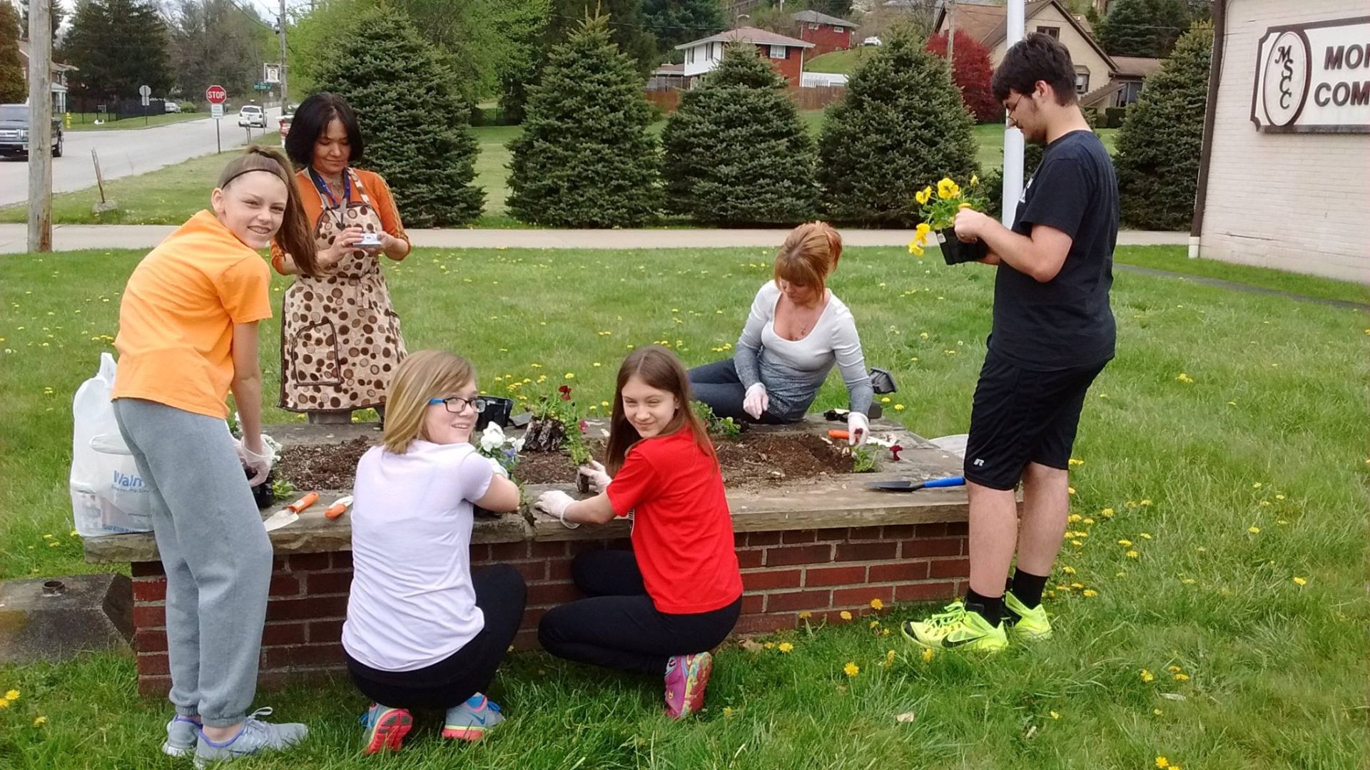 Some St. Sebastian Students planting flowers at the Monessen Senior Community Center​​​
